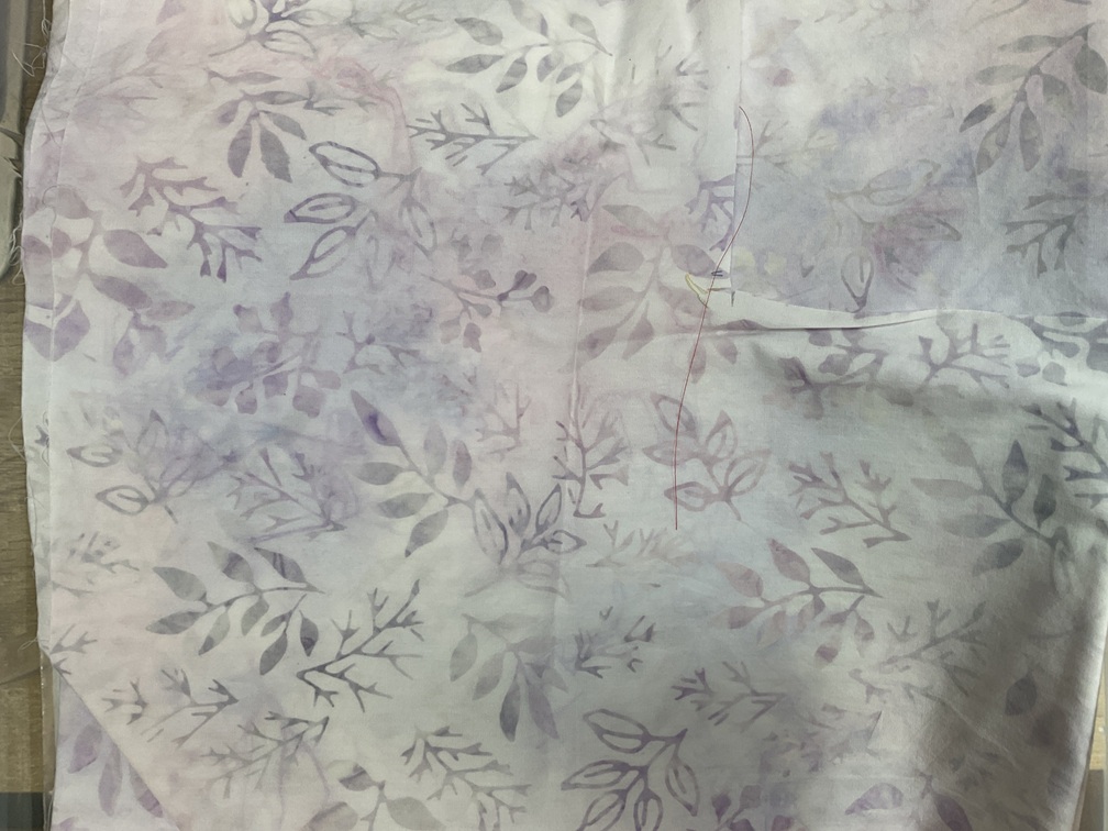 Batik fabric - very pale blue/lavender background, grey/lavender sprigs; no mark